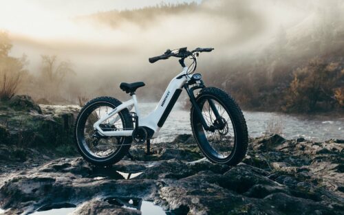 Electric Bike Standing on Rocks Crossing River